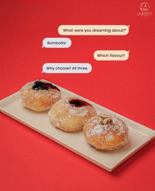 Three filled bombolinis on a white tray